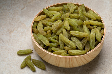 Bowl with sweet green Afghans raisins close up
