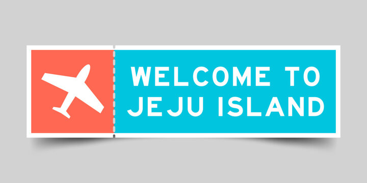 Orange and blue color ticket with plane icon and word welcome to jeju island on gray background