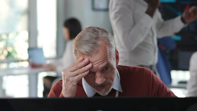 Closeup portrait of stressed mature sales manager receive bad news on computer