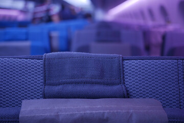purple color Empty passenger airplane seats in the cabin