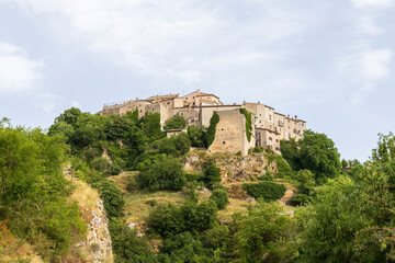 Village on top of a mountain in the middle of the green. Ancient stone houses, Abruzzo, Italy.