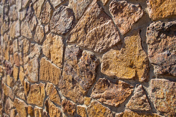 Wall of rough boulders. Stone masonry.