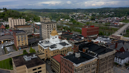 Low altitude aerial view with stormy sky centered on the Marion County courthouse in Fairmont, West Virginia.