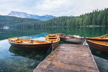 Black lake with boats on mount Durmitor, Montenegro