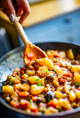 Woman cooking tasty vegetable stew in pan on kitchen