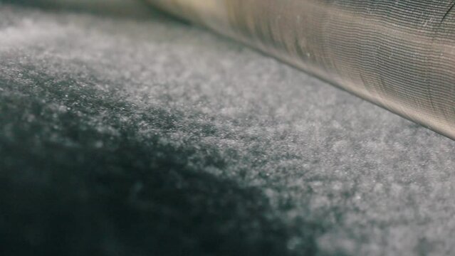 Synthetic winterizer on the conveyor line, close-up. Factory for the production of non-woven materials. Production of synthetic winterizer close-up. Syntepon manufacturing process