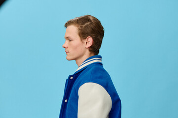 cute man in a blue bomber jacket on a blue background