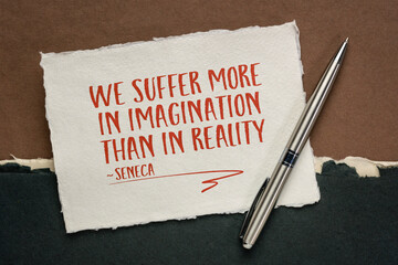 We suffer more in imagination than in reality, Seneca (Roman Stoic philosopher) - handwriting on a white Khadi rag paper against abstract landscape in earth tones, stress and mindset concept - obrazy, fototapety, plakaty