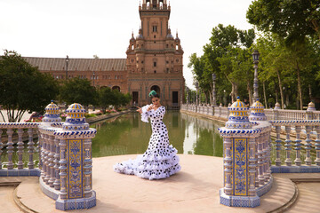 Flamenco dancer woman, beautiful brunette teenager dressed in typical costume with ruffles and...