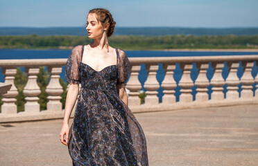 Portrait of a young woman in summer flowers dress