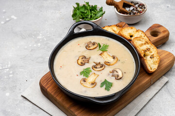 Mushroom soup with bread and fresh mushrooms, autumn seasonal cream soup with vegetables