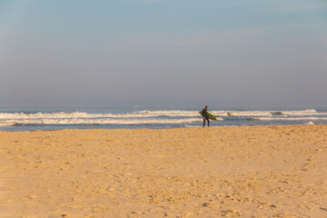 Fototapeta na wymiar Surfer coming out of the sea