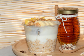 Bowl of fresh yogurt with oat orange, pineapple ,fruit served for good health , breakfast and lose weight