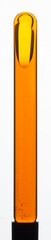 Yellow viscous liquid sunflower lecithin with bubbles in a transparent test tube on a white background