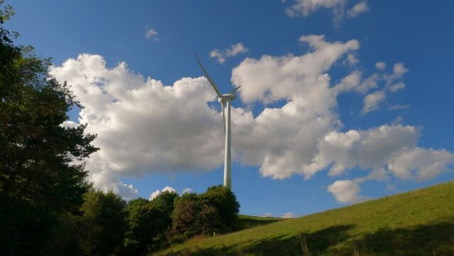 An ecological source of energy. Windmill on a mountain in Munich. Wind turbine in Germany. Turbine Frottmaninger Mullberg. Wind turbine, Gut Grosslappen, Munich, Bavaria, Germany. Green energy 