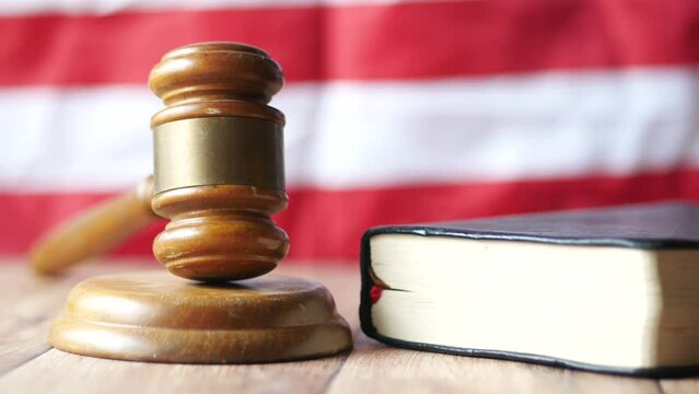 a gavel and book on a american flag 
