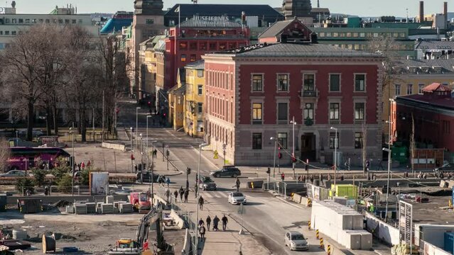 Crowded people walking and traffic at the crossroad in central city with traditional buildings at Oslo, Norway