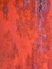 Peeled red paint on the iron background