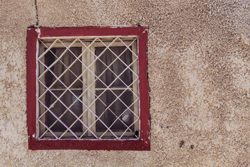 Ancient structure and old, red painted window