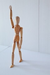 Greeting or leadership concept represented in a wooden doll	