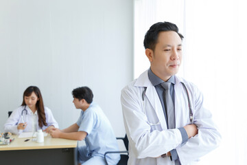 Portrait of male senior doctor feeling good mood and thinking with doctor and patient interaction together on the background