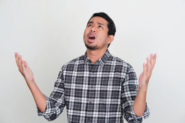 Asian man looking up showing regret expression