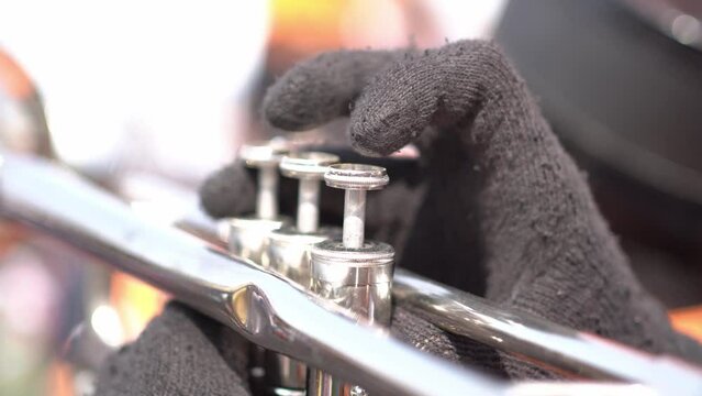 People blowing trumpets in marching band on blurred background