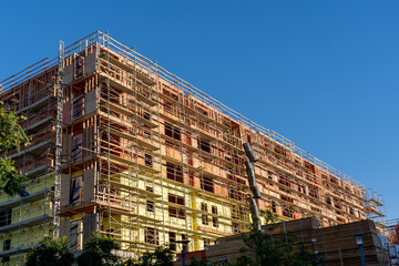 San Diego, CA, USA - July 9, 2022: Mid-Rise wood-frame construction site is seen in San Diego, CA, USA.