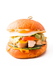 Sandwich with fried egg and chicken fillet on white background.