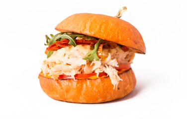 Burger with chicken fillet, pineapple, arugula, tomatoes, bacon and sauce on a white background