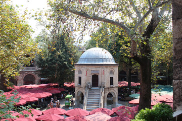 Tea gardens with big umbrellas in Koza Han Silk Bazaar. Koza Han is historical place from Ottoman times in Bursa, Turkey