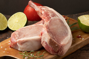 Raw pork rib steak on cutting board.
