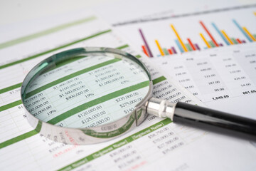 Magnifying glass on charts graphs paper. Financial development, Banking Account, Statistics, Investment Analytic research data economy, Stock exchange trading, Business office company meeting concept.