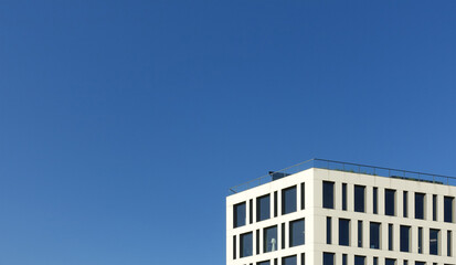 Corner of white skyscrapers against sky