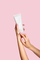 Woman applying lotion to hand. Cosmetic product branding mockup. Daily skincare and body care...