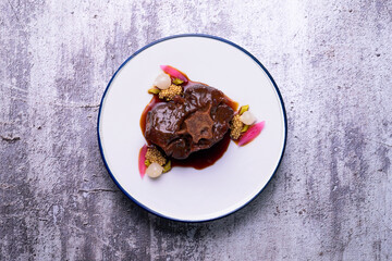 Stewed oxtail. Traditional Spanish tapa cooked with red wine and vegetables.