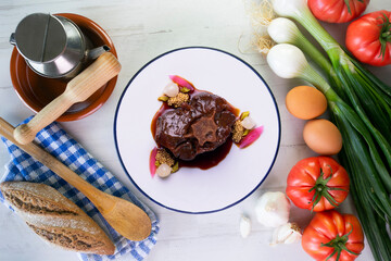 Stewed oxtail. Traditional Spanish tapa cooked with red wine and vegetables.