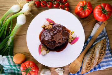 Stewed oxtail. Traditional Spanish tapa cooked with red wine and vegetables.
