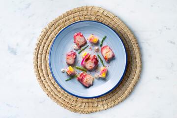 Octopus with potato, purple onion and paprika. Spanish modern tapa.