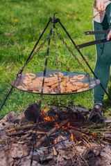grilling chicken breast with real fire in a nature
