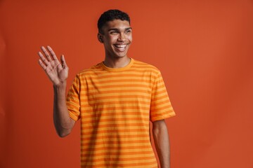 Young handsome smiling happy african man with piercing waving