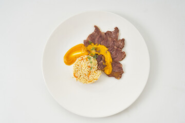 juicy beef in creamy mustard sauce with bulgur porridge and vegetables
