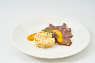 juicy beef in creamy mustard sauce with bulgur porridge and vegetables