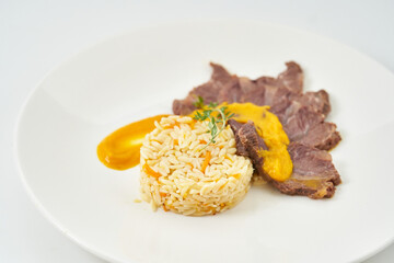 juicy beef in creamy mustard sauce with bulgur porridge and vegetables