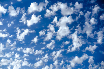 White small fluffy clouds in deep blue sky, mackerel skies