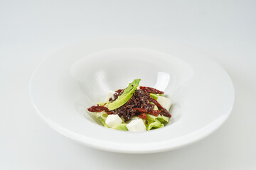 piece of fresh lettuce, sun-dried tomatoes, feto cheese