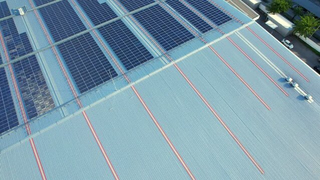 Top view of a solar power station on building roof, Renewable green energy. Clean energy industry. drone footage. 4k
