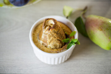 pear baked in curd dough in a small ceramic form