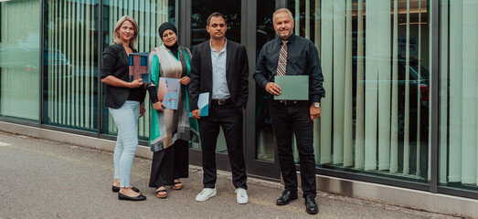 Group portrait of happy diverse colleagues of different ages. United businesspeople of 30s and 50s looking at camera. Team of trainee interns and coaches posing together in office. Teamwork concept