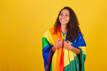 Young black Brazilian woman, soccer fan. with the LGBT and Brazilian flag, Fight against prejudice....
